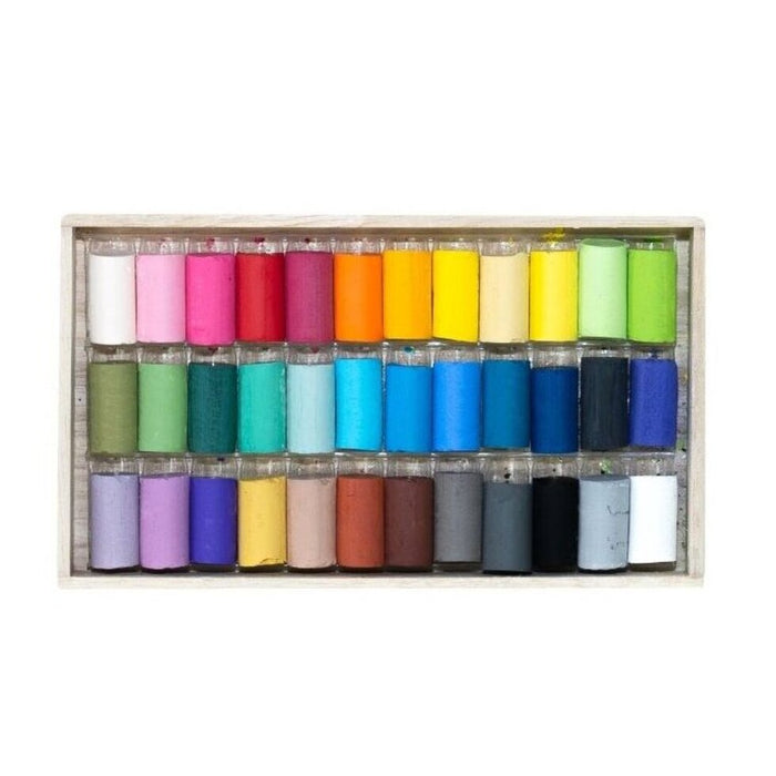 Set of colorful pastels in a wooden box on a white background